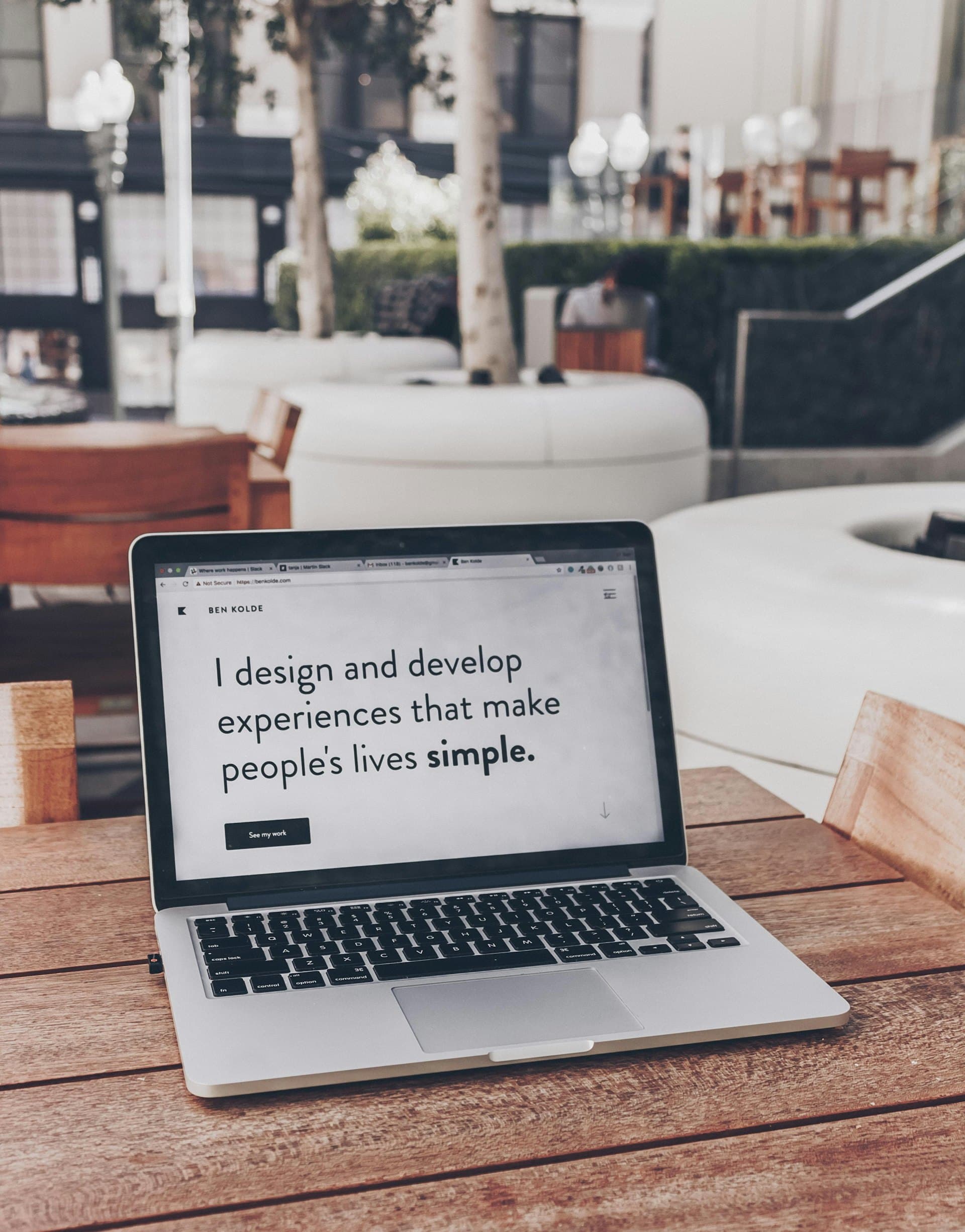 Laptop on a desk showing a design portfolio
